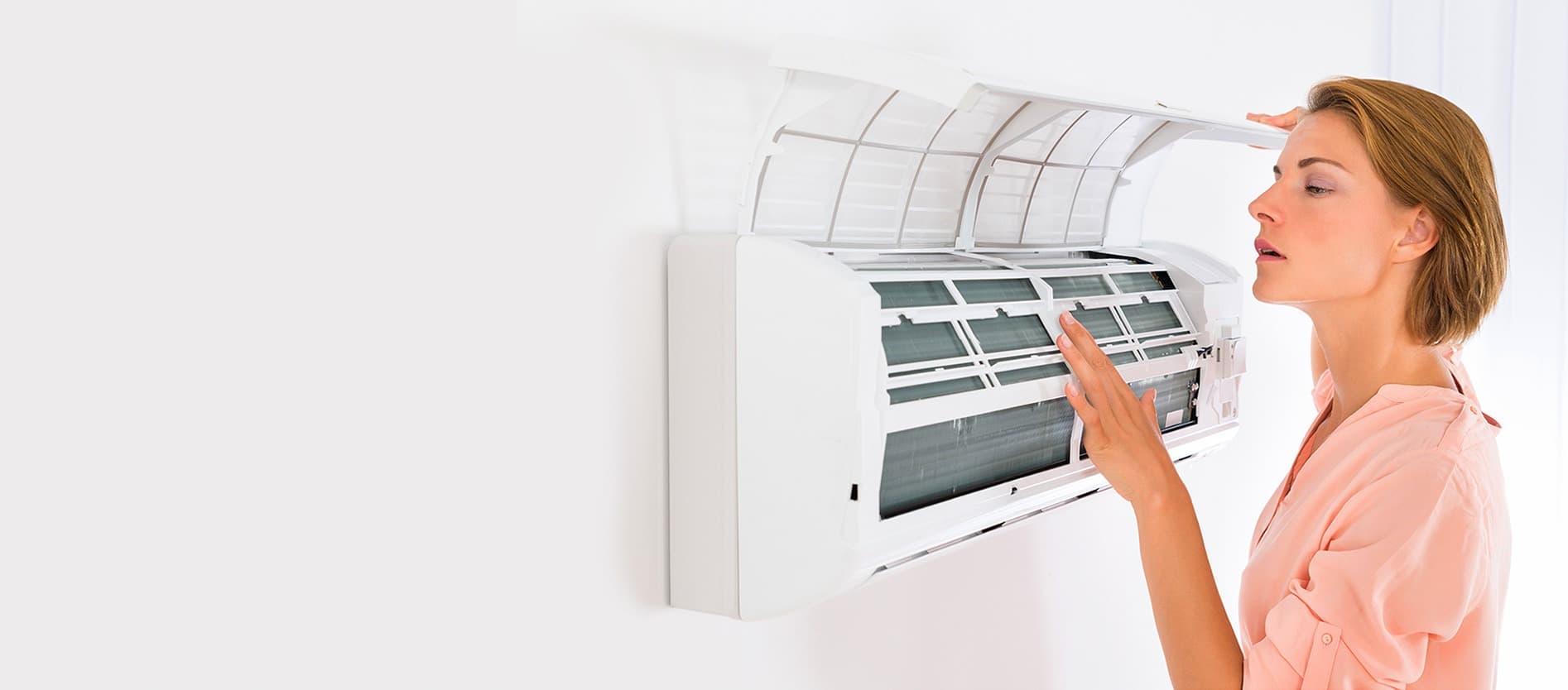 Technician checking an indoor air-conditioning unit.